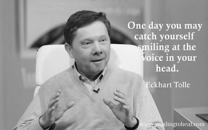 Black and white photo of Eckhart Tolle gesturing during a talk