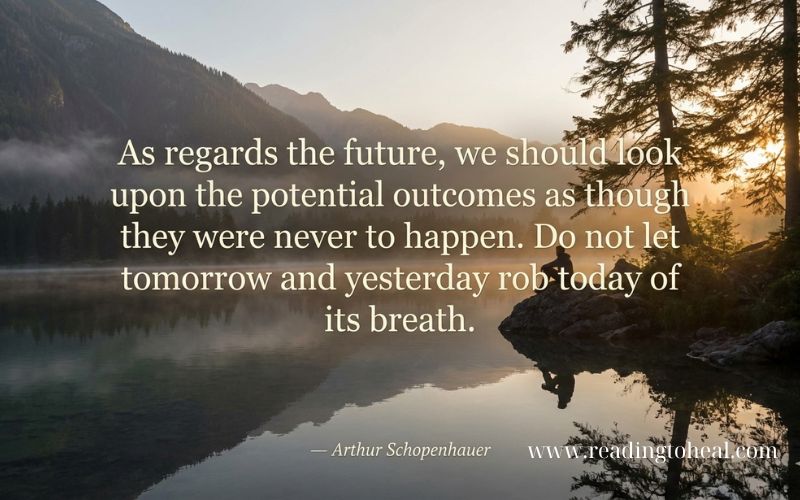 A person sitting by a calm lake at sunrise with a Schopenhauer quote: 'Do not let tomorrow and yesterday rob today of its breath.'