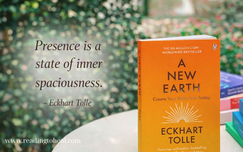 Eckhart Tolle quote about presence and inner spaciousness with A New Earth book cover in a garden setting.