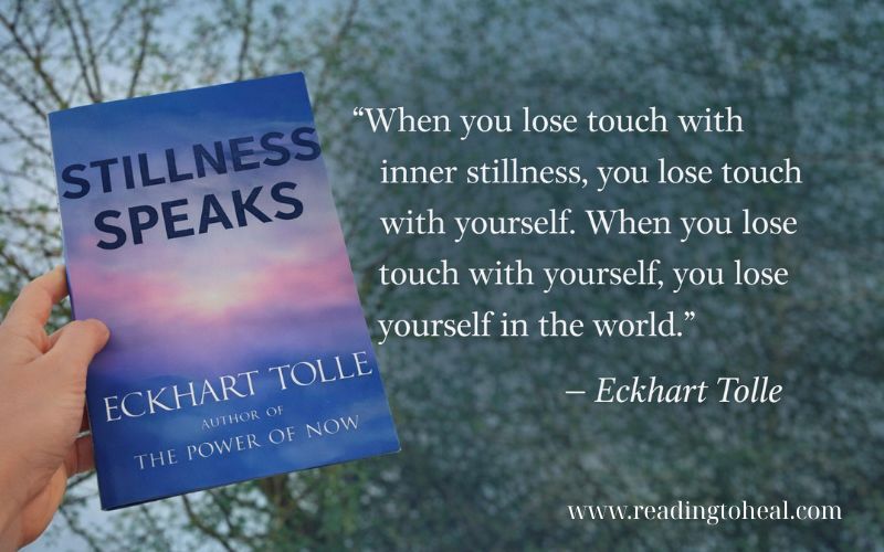 Eckhart Tolle Stillness Speaks book held outdoors with quote about losing touch with inner stillness, mindfulness concept